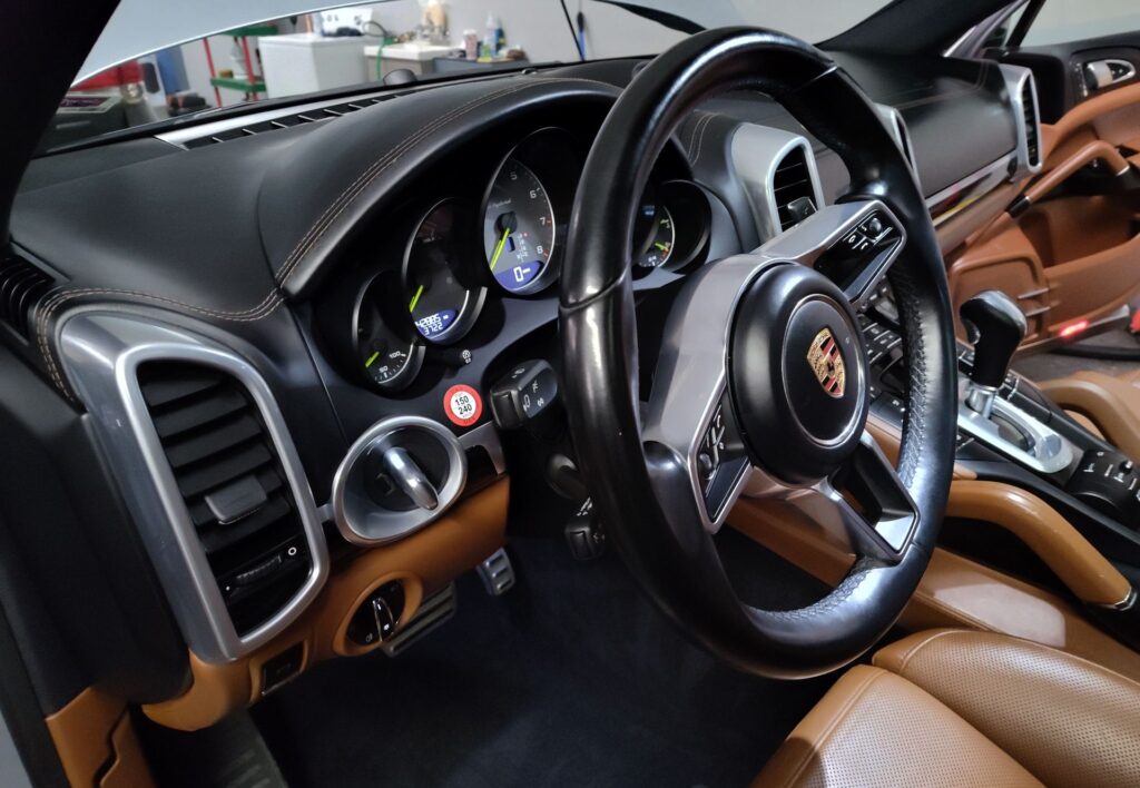 Interior of a sports car with tan and black leather seats and accents, learn about Elite Reserve today!